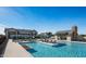 A beautiful community pool featuring a large pool deck, comfortable lounge chairs, and inviting umbrellas at 613 W Winchester Dr, Chandler, AZ 85286