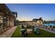 Outdoor fire pit area with Adirondack chairs and unique barrel tables, creating a cozy social space at 613 W Winchester Dr, Chandler, AZ 85286
