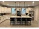 A modern kitchen with white cabinets, a large island with seating, stainless steel appliances, and modern backsplash at 613 W Winchester Dr, Chandler, AZ 85286