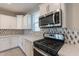 A modern kitchen with stainless steel appliances, white countertops, and backsplash at 613 W Winchester Dr, Chandler, AZ 85286