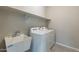 Bright laundry room with a sink, countertop, and included washer and dryer at 613 W Winchester Dr, Chandler, AZ 85286