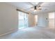 Carpeted main bedroom with large windows, ceiling fan, sliding glass door and walk in closet at 613 W Winchester Dr, Chandler, AZ 85286
