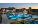 Community pool featuring a spacious pool, sun loungers, and inviting ambiance during dusk at 613 W Winchester Dr, Chandler, AZ 85286