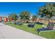Poolside lawn area with comfortable lounge chairs and umbrellas, offering a perfect spot for relaxation at 613 W Winchester Dr, Chandler, AZ 85286