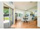 Dining area with glass table, seating for six, and sliding glass doors to the exterior at 6301 S Tournament Ln, Chandler, AZ 85249