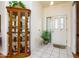 Inviting entryway featuring tile floors, a display cabinet, and plenty of natural light at 6301 S Tournament Ln, Chandler, AZ 85249