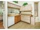 Efficient kitchen with light wood cabinets, laminate counters, and a white dishwasher at 6301 S Tournament Ln, Chandler, AZ 85249