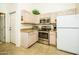 Bright kitchen featuring stainless steel appliances and ample cabinet space at 6301 S Tournament Ln, Chandler, AZ 85249