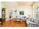 Spacious living room with wood floors, high ceilings, and a comfortable seating area at 6301 S Tournament Ln, Chandler, AZ 85249