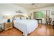 Bright main bedroom with a large window and hardwood floors at 6301 S Tournament Ln, Chandler, AZ 85249