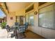 Inviting covered patio featuring comfortable seating and sliding door access to the home at 6301 S Tournament Ln, Chandler, AZ 85249