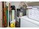 View of water heater, water softener, and shelving in utility closet at 6301 S Tournament Ln, Chandler, AZ 85249