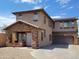 Two-story home featuring a stone accented entry and garage with solar panels at 6620 W Shaw Butte Dr, Glendale, AZ 85304