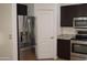 Modern kitchen with stainless steel fridge and appliances, and dark wood cabinets at 6620 W Shaw Butte Dr, Glendale, AZ 85304
