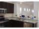 Kitchen with granite countertops, stainless appliances and dark cabinets at 6620 W Shaw Butte Dr, Glendale, AZ 85304