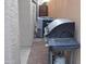 View of the side yard with brick pavers, BBQ and AC unit at 6620 W Shaw Butte Dr, Glendale, AZ 85304