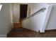 View down staircase showing wood stairs and railing with dark trim at 6620 W Shaw Butte Dr, Glendale, AZ 85304