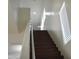 Staircase featuring white walls, handrails and dark wood stairs at 6620 W Shaw Butte Dr, Glendale, AZ 85304