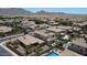 Neighborhood aerial view of homes with tile roofs, pools, and mountain views in the distance at 6840 S Crystal Way, Chandler, AZ 85249