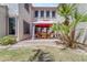 Backyard patio with red umbrella and wicker furniture, surrounded by lush landscaping at 6840 S Crystal Way, Chandler, AZ 85249