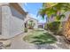 Well-maintained backyard with lush grass, beautiful landscaping, and a stone-lined perimeter at 6840 S Crystal Way, Chandler, AZ 85249