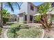 A view of the backyard featuring a pool, patio with an umbrella, and landscaped lawn at 6840 S Crystal Way, Chandler, AZ 85249