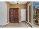 Inviting entryway features tile flooring, a large wooden cabinet, and access to the outdoor patio at 6840 S Crystal Way, Chandler, AZ 85249