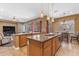 Spacious kitchen island with granite countertops and pendant lighting overlooking living area at 6840 S Crystal Way, Chandler, AZ 85249