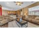 Comfortable living room with open floor plan, natural light, and views of the kitchen at 6840 S Crystal Way, Chandler, AZ 85249