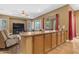 Open-concept living area with bar top, comfortable seating, and ample natural light at 6840 S Crystal Way, Chandler, AZ 85249