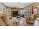 Relaxing living room with plush seating, natural light, and a ceiling fan at 6840 S Crystal Way, Chandler, AZ 85249