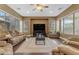 Cozy living room featuring comfortable sofas, a ceiling fan, and large windows at 6840 S Crystal Way, Chandler, AZ 85249