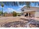 Large backyard with desert landscaping, patio seating, and shade tree at 706 N El Dorado Dr, Gilbert, AZ 85233
