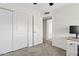 This bedroom features neutral carpeting, ceiling fan and closet for ample storage at 706 N El Dorado Dr, Gilbert, AZ 85233