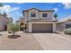 Charming two-story home with a well-maintained yard and attached two car garage, under a bright blue sky at 706 N El Dorado Dr, Gilbert, AZ 85233