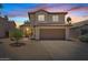 Charming two-story home with a well-maintained yard and attached two car garage, under a colorful sunset at 706 N El Dorado Dr, Gilbert, AZ 85233
