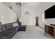Bright and spacious living room with large windows, plush gray sofa, high ceilings, and neutral carpet at 706 N El Dorado Dr, Gilbert, AZ 85233