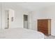 Bright bedroom with a view to the bath, closet, and a wooden dresser at 706 N El Dorado Dr, Gilbert, AZ 85233