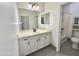 Well-lit bathroom featuring a modern vanity with a sink and bathtub at 7116 W Sophie Ln, Laveen, AZ 85339