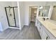 Bathroom with a shower, double sinks, and a walk-in closet at 7116 W Sophie Ln, Laveen, AZ 85339