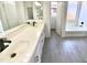 Bright bathroom with double vanity, white cabinets, and black fixtures at 7116 W Sophie Ln, Laveen, AZ 85339