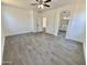 Expansive bedroom boasts wood-look tile and seamless access to a pristine bathroom at 7116 W Sophie Ln, Laveen, AZ 85339