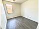 This bedroom features a window and hardwood floors at 7116 W Sophie Ln, Laveen, AZ 85339