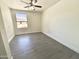 Bright, empty bedroom features neutral walls and flooring, plus a window for natural light at 7116 W Sophie Ln, Laveen, AZ 85339