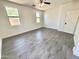 Cozy bedroom with wood-look flooring, a window, and access to a closet at 7116 W Sophie Ln, Laveen, AZ 85339