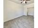 Empty bedroom with tile flooring, white walls, and ceiling fan, ready for personalization at 7116 W Sophie Ln, Laveen, AZ 85339