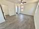 Bright bedroom showcasing wood-look tile, neutral walls, and an arched doorway at 7116 W Sophie Ln, Laveen, AZ 85339