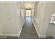 Spacious hallway featuring neutral tile flooring and views of the home's interior and backyard at 7116 W Sophie Ln, Laveen, AZ 85339