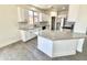 Bright kitchen features white cabinets, gray countertops, stainless steel appliances, and a breakfast bar at 7116 W Sophie Ln, Laveen, AZ 85339