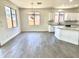 Open floor plan connects the kitchen, featuring white cabinets, to the spacious dining area at 7116 W Sophie Ln, Laveen, AZ 85339